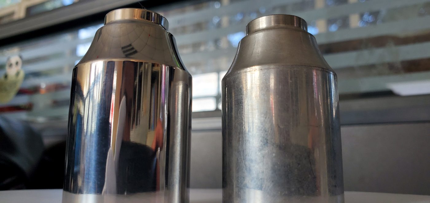 Real concave aluminum polishing sample showing bright polished surface and cloudy unfinished surface comparison