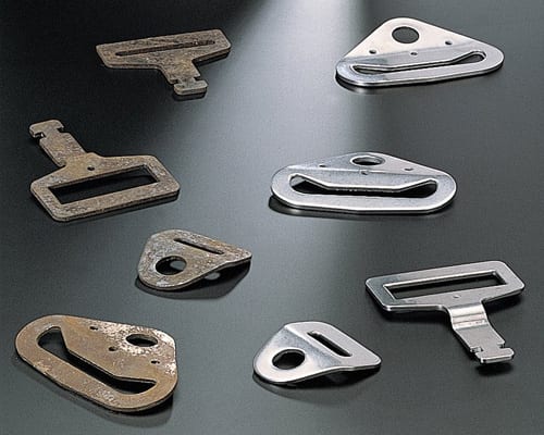 Stamped metal buckle components used for a deburring and surface finishing evaluation
